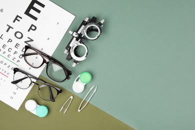 Flat lay composition with vision test chart and glasses on color background, space for text