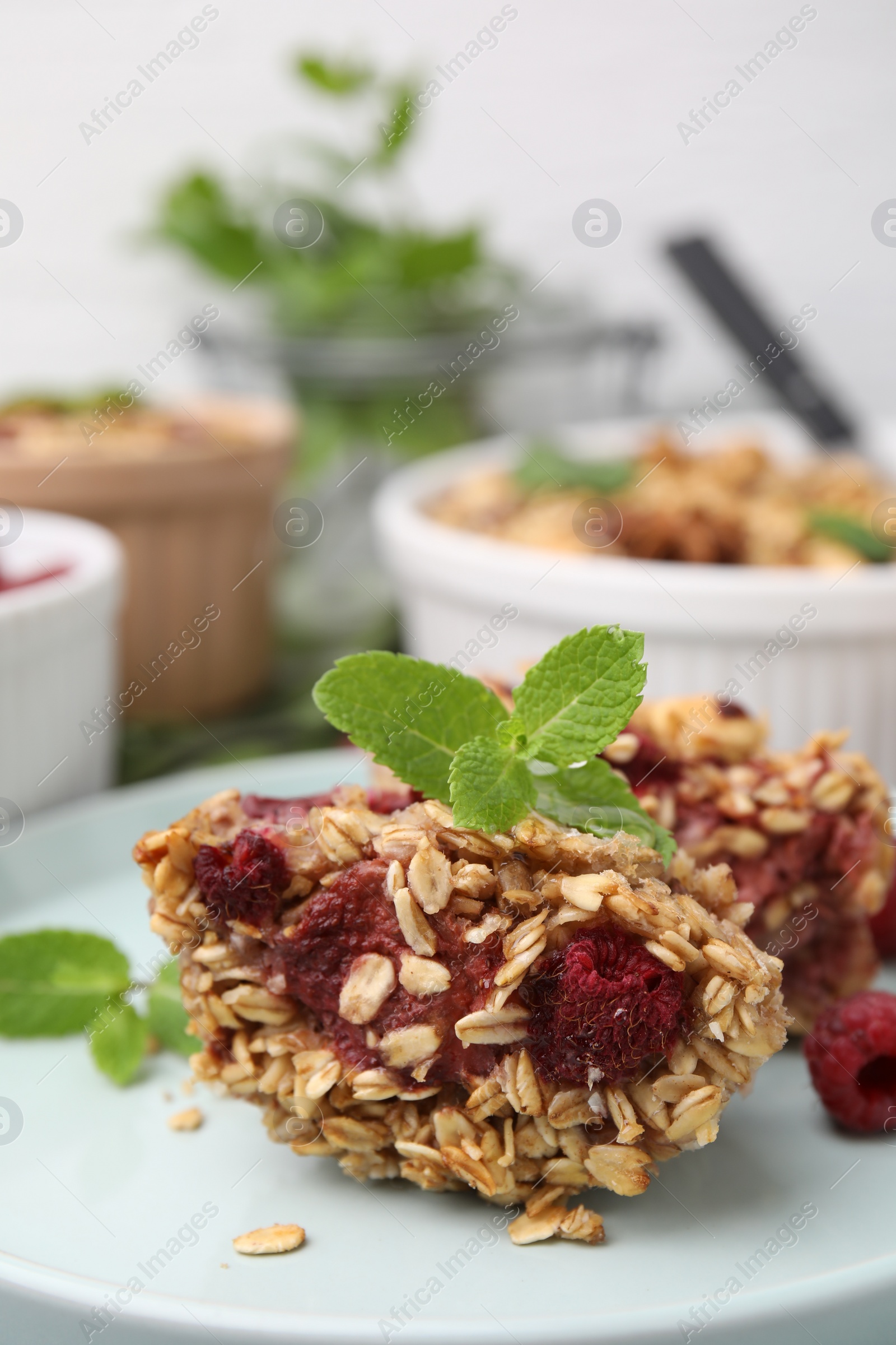 Photo of Tasty baked oatmeal with raspberries on table, closeup