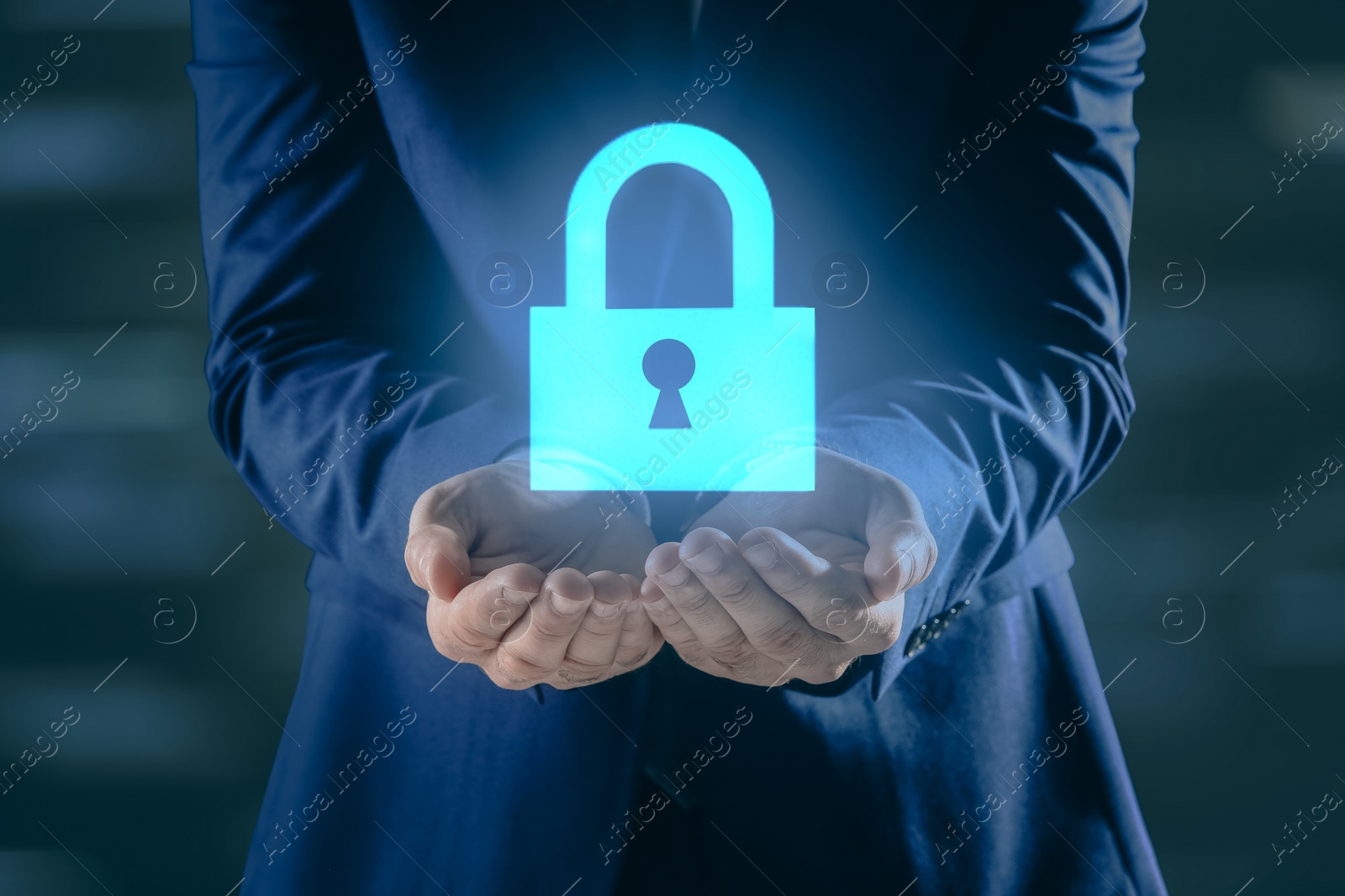 Image of Cyber security concept. Man holding virtual icon of padlock on dark background, closeup