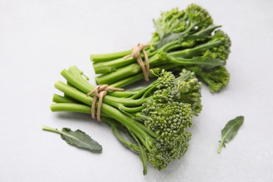 Photo of Fresh raw broccolini on white background, closeup. Healthy food