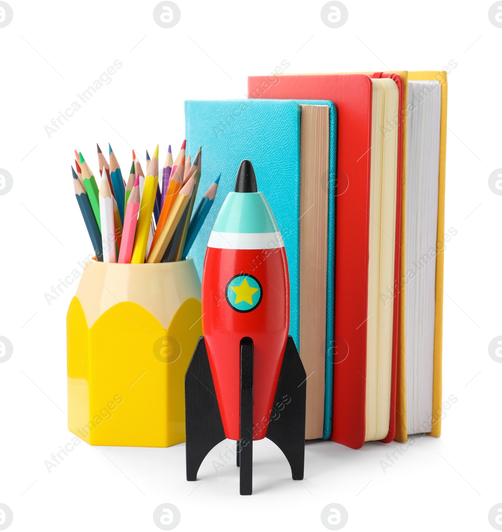 Photo of Bright toy rocket and school supplies on white background