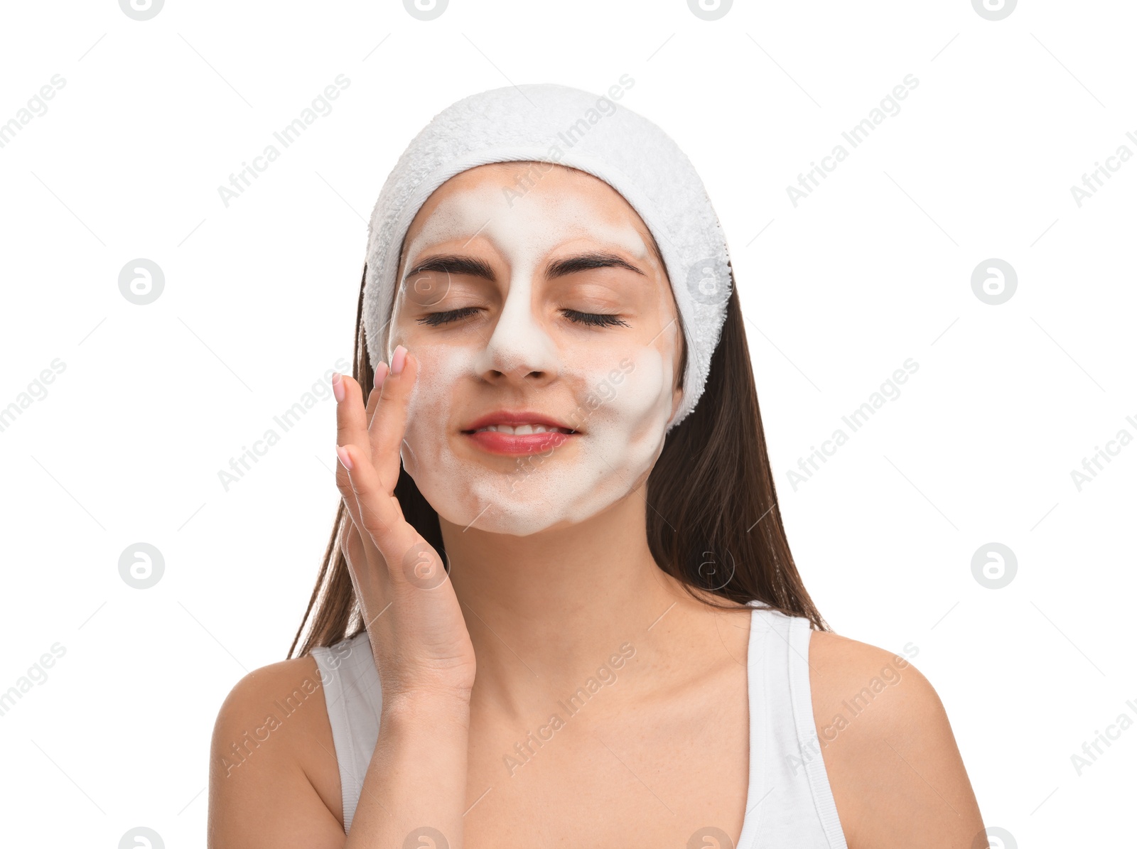 Photo of Young woman with headband washing her face on white background