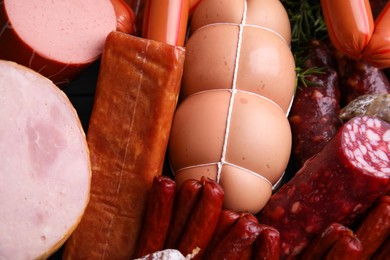 Different types of tasty sausages as background, top view