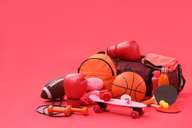 Photo of Many different sports equipment on red background, space for text