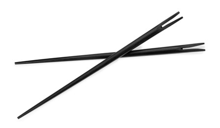 Photo of Pair of black chopsticks isolated on white, top view