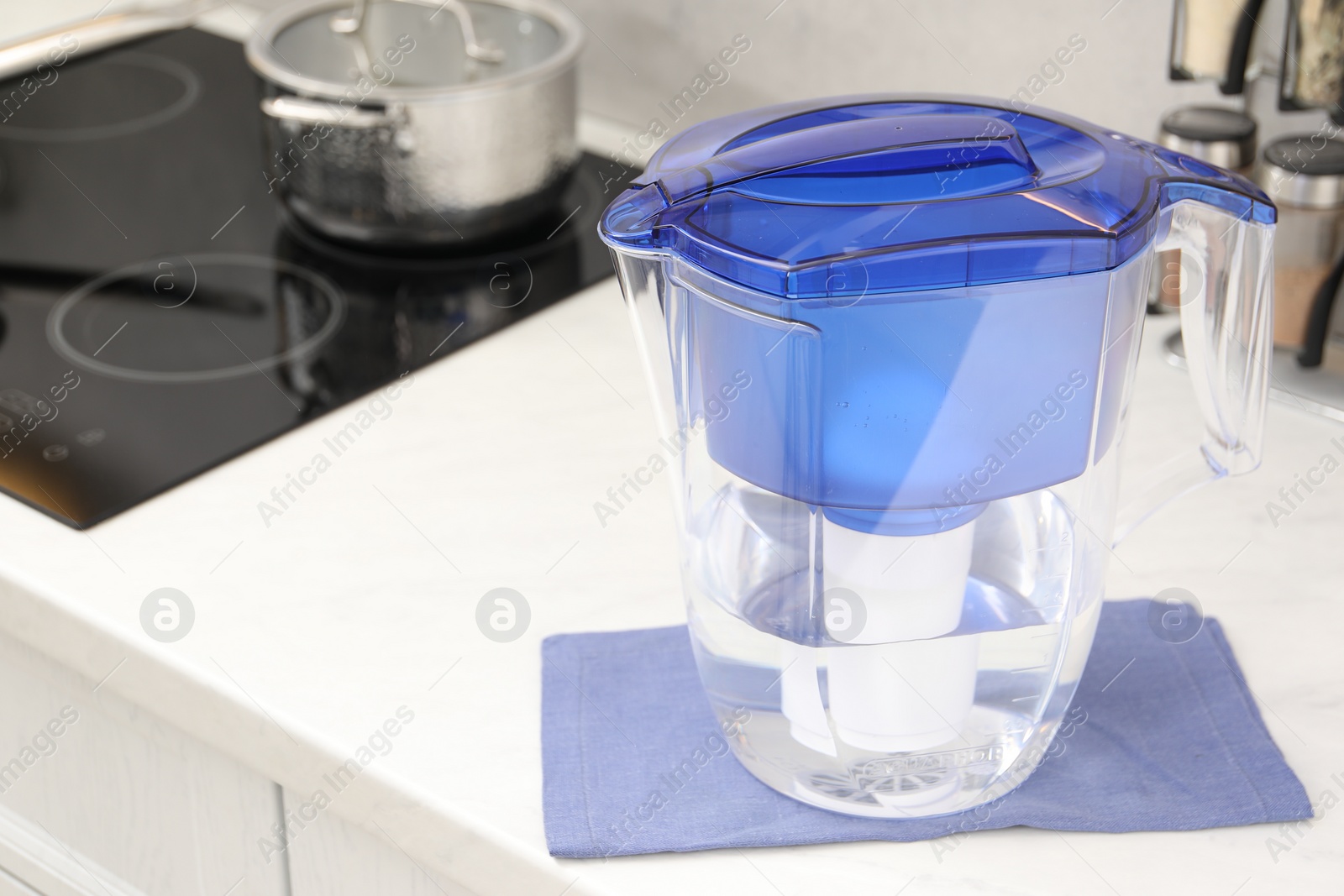 Photo of Water filter jug on white countertop in kitchen