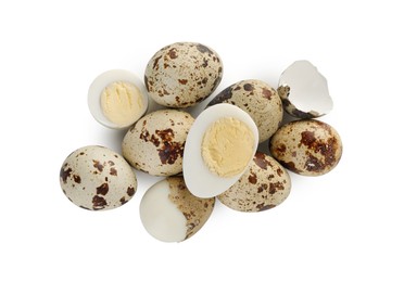 Unpeeled and peeled hard boiled quail eggs on white background, top view