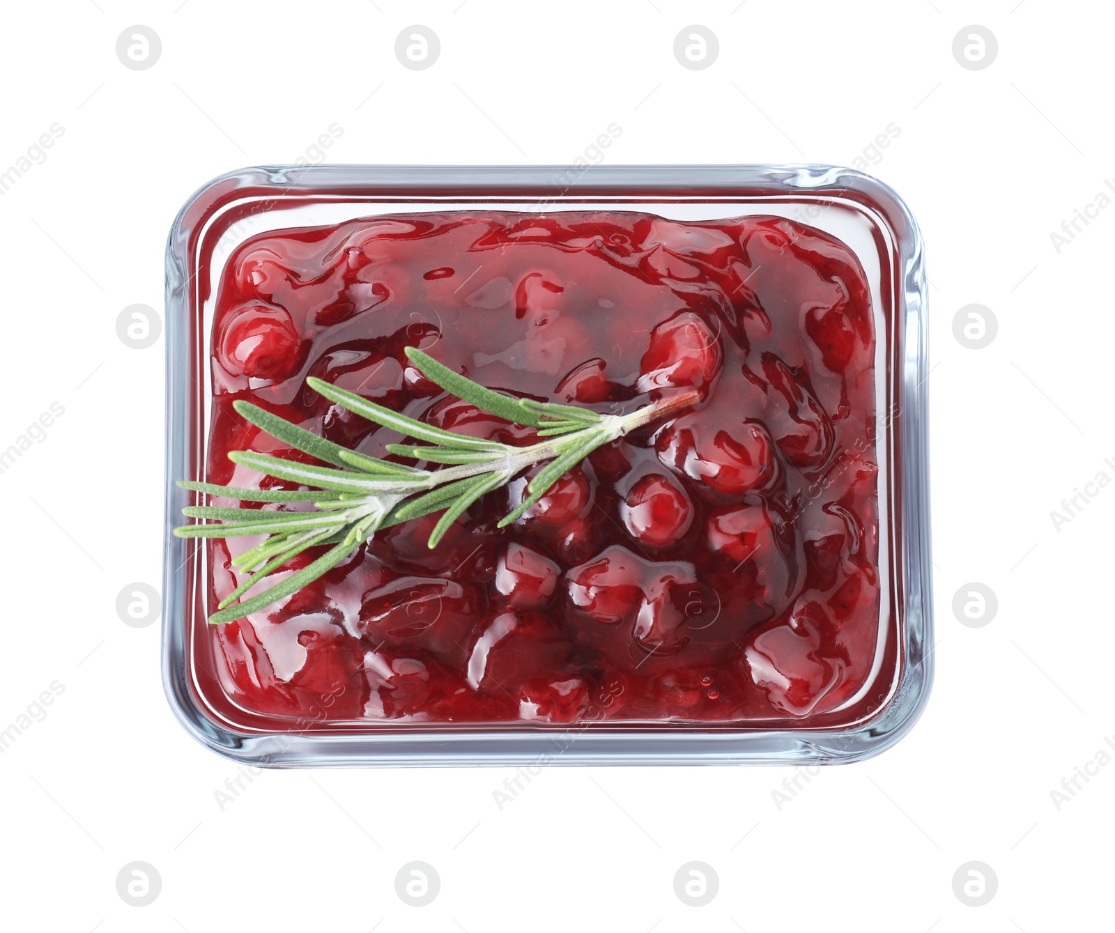 Photo of Fresh cranberry sauce and rosemary in glass bowl isolated on white, top view