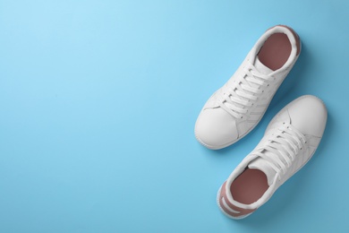 Pair of sneakers on color background, flat lay. Space for text