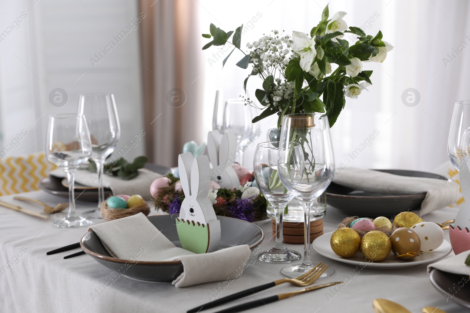 Photo of Beautiful Easter table setting with festive decor indoors