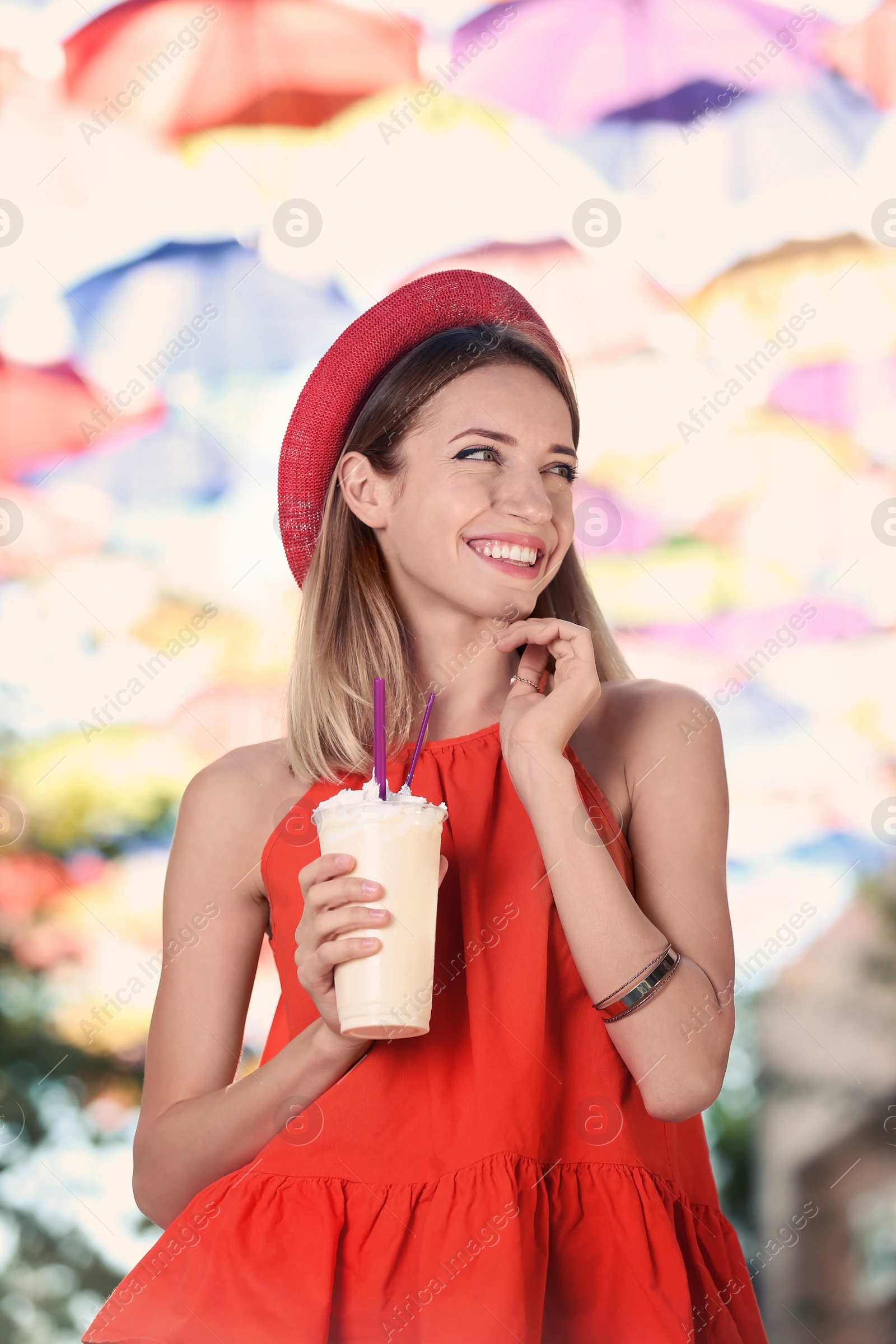 Photo of Beautiful woman with tasty drink on city street