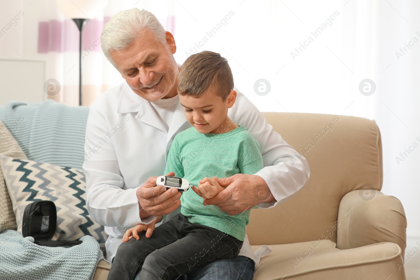 Photo of Doctor measuring patient's blood sugar level with digital glucose meter at home. Diabetes control