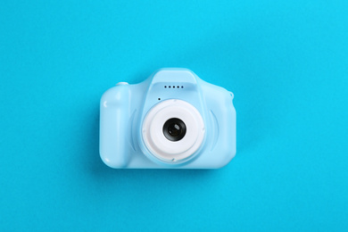 Photo of Toy camera on blue background, top view