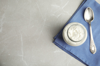 Tasty organic yogurt on grey marble table, top view. Space for text