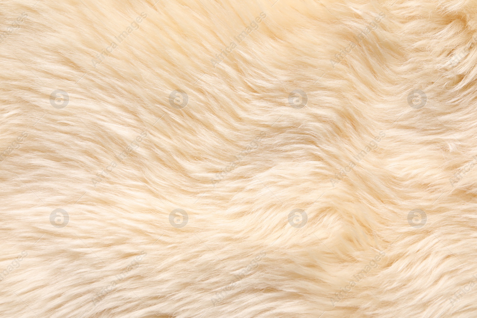 Photo of Texture of beige faux fur as background, top view