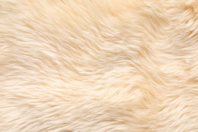 Photo of Texture of beige faux fur as background, top view
