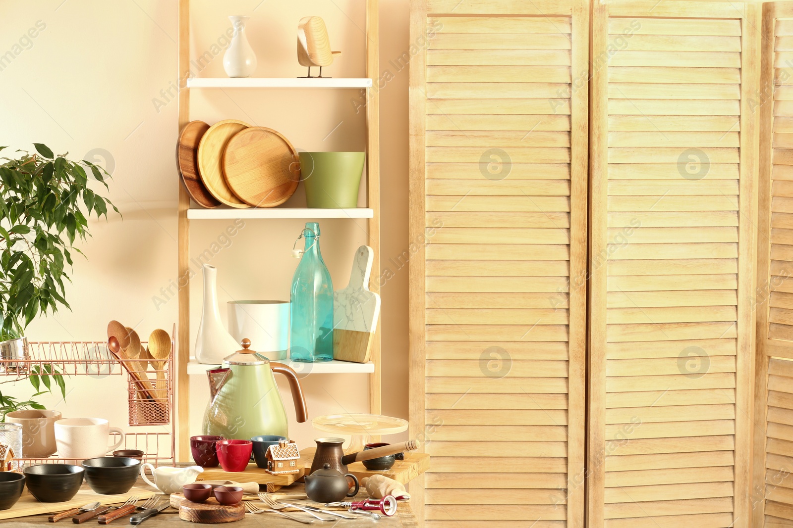 Photo of Many different cooking utensils in room, space for text. Garage sale