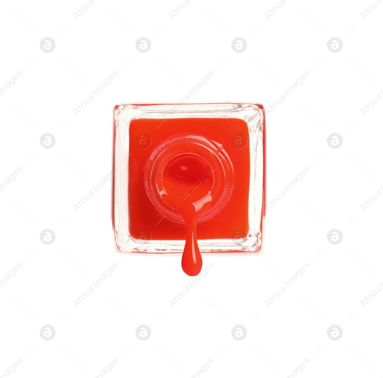 Photo of Pouring color nail polish from bottle on white background