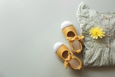 Photo of Stylish child clothes and shoes on grey background, flat lay. Space for text