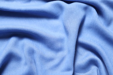 Texture of light blue crumpled fabric as background, top view