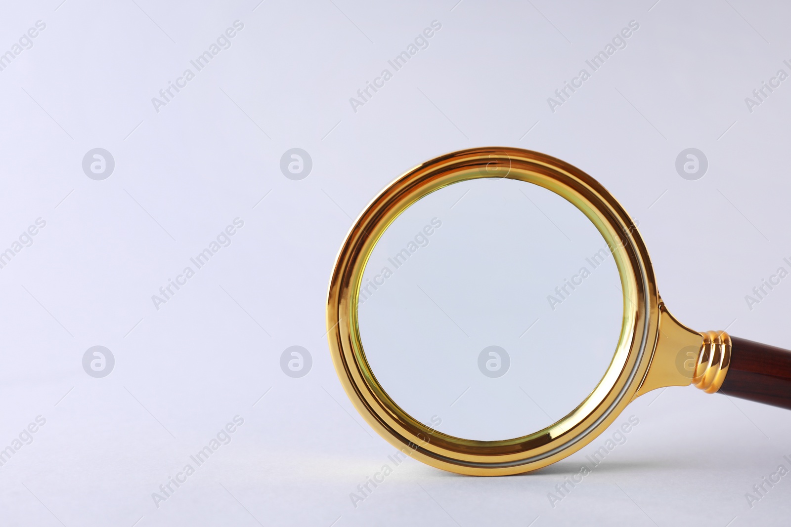 Photo of Magnifying glass with handle on white background. Space for text