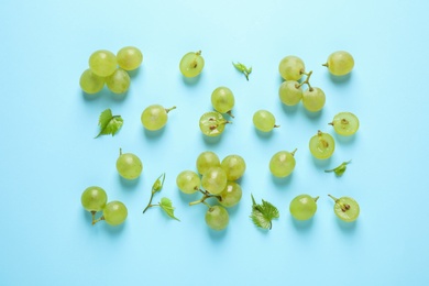Photo of Flat lay composition with fresh ripe juicy grapes on light blue background