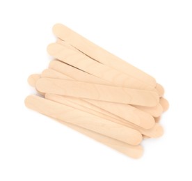 Disposable wooden spatulas for depilatory wax on white background, top view