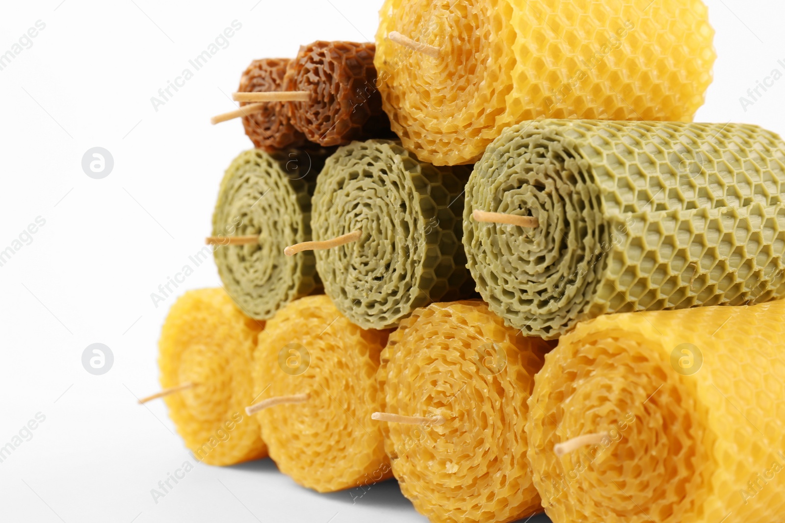 Photo of Stylish elegant beeswax candles on white background, closeup