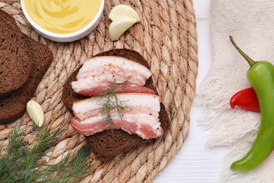 Photo of Sandwich with pork fatback on white table, flat lay