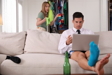 Photo of Man trying to work while arguing with his wife. Stay at home concept