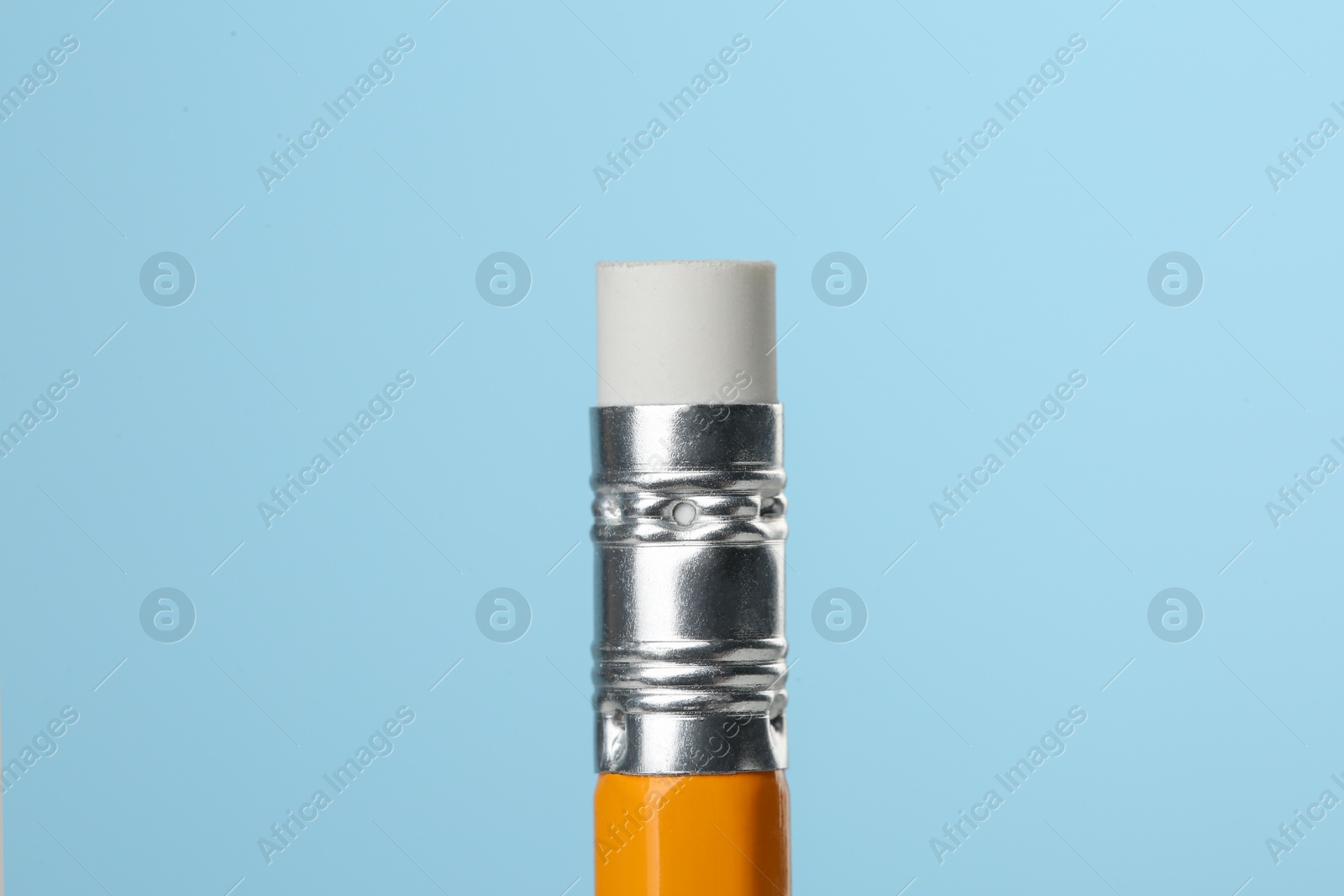 Photo of Graphite pencil with eraser on turquoise background, macro view