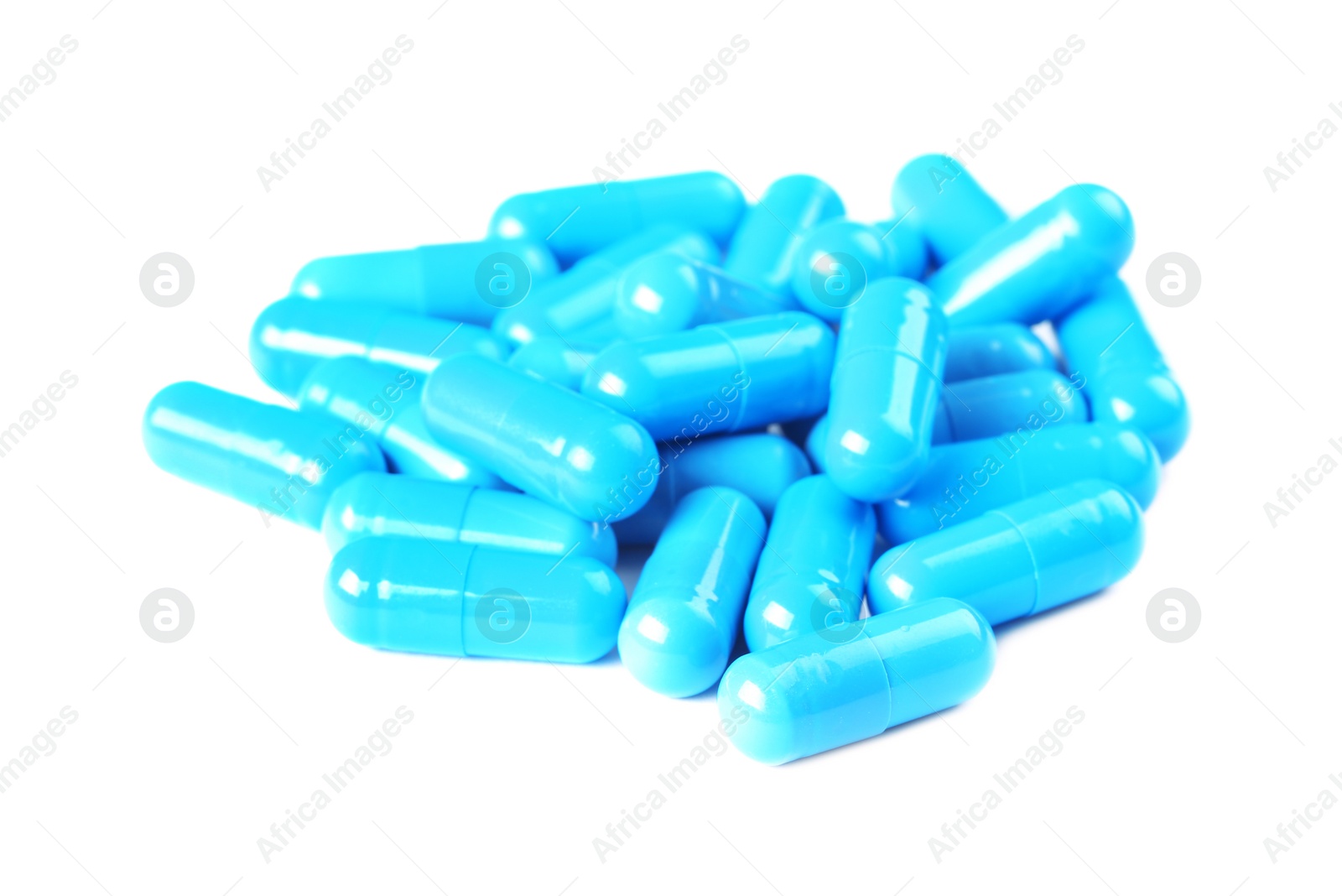 Photo of Pile of blue pills on white background