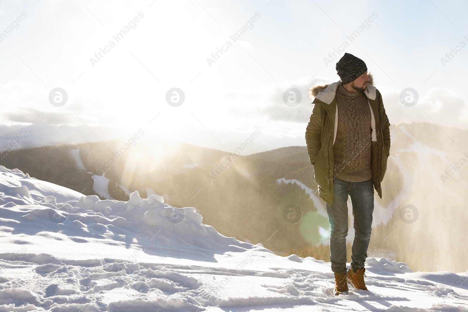 Photo of Man spending winter vacation in mountains. Space for text