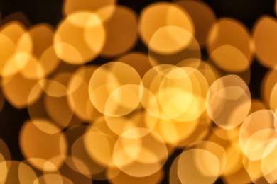 Photo of Beautiful golden lights on dark background. Bokeh effect