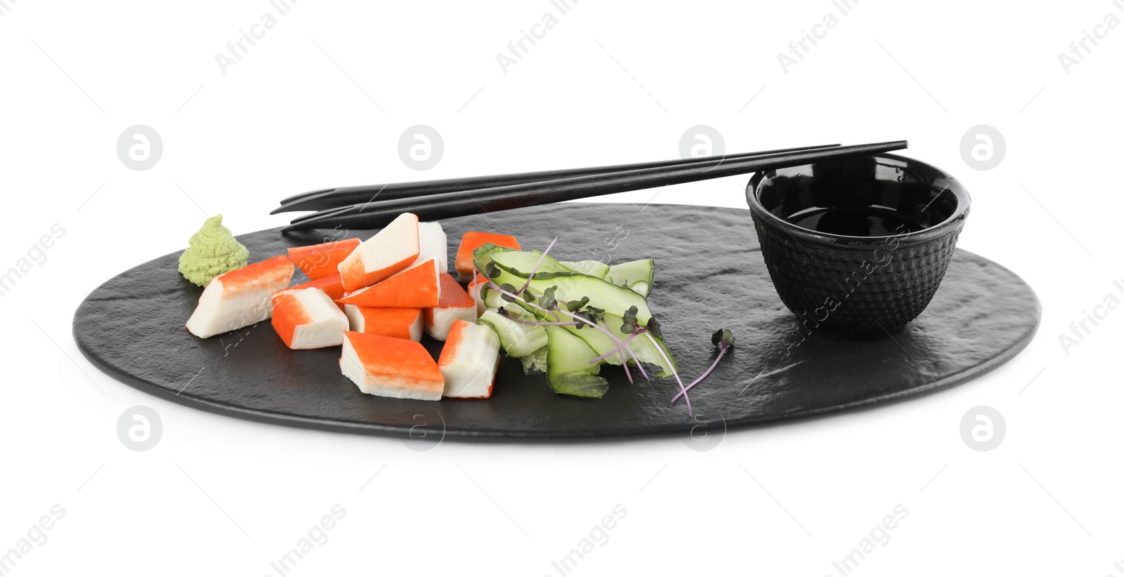 Photo of Fresh crab sticks with cucumber and soy sauce on white background