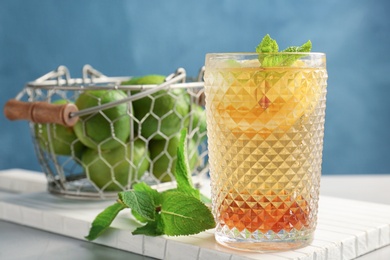 Photo of Glass of delicious mint julep cocktail on board