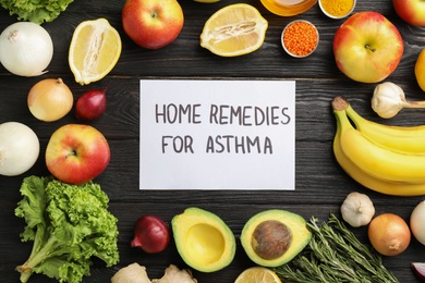 Natural products and note with text HOME REMEDIES FOR ASTHMA on wooden background, flat lay