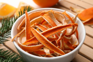 Photo of Dry peels, oranges and fir branch on table, closeup