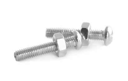Metal carriage bolts with hex nuts on white background