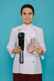 Photo of Chef holding sous vide cooker and meat in vacuum pack on light blue background