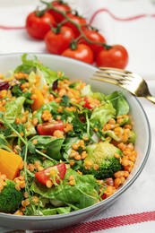 Delicious salad with lentils and vegetables served on table, closeup