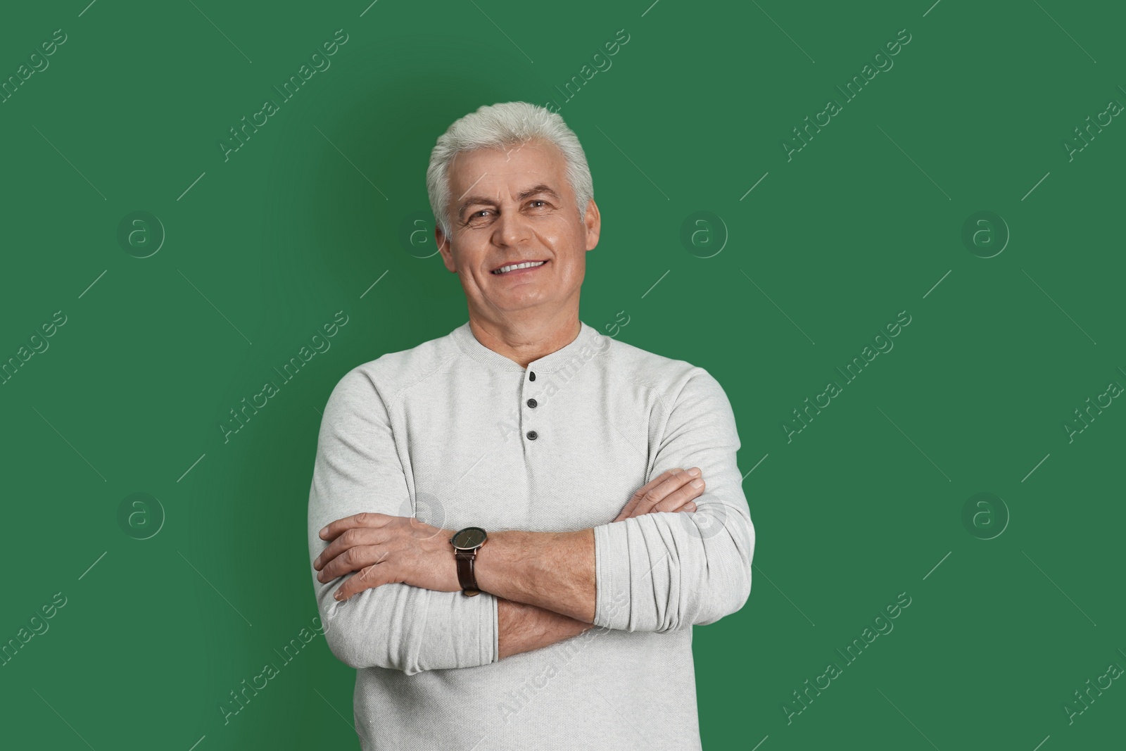 Photo of Portrait of handsome mature man on color background