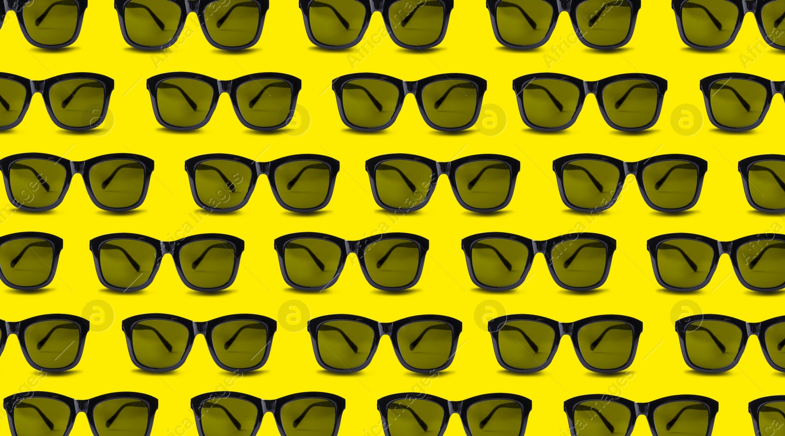 Image of Many stylish sunglasses on yellow background. Seamless pattern design