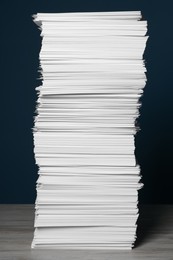 Photo of Stack of white paper sheets on blue background