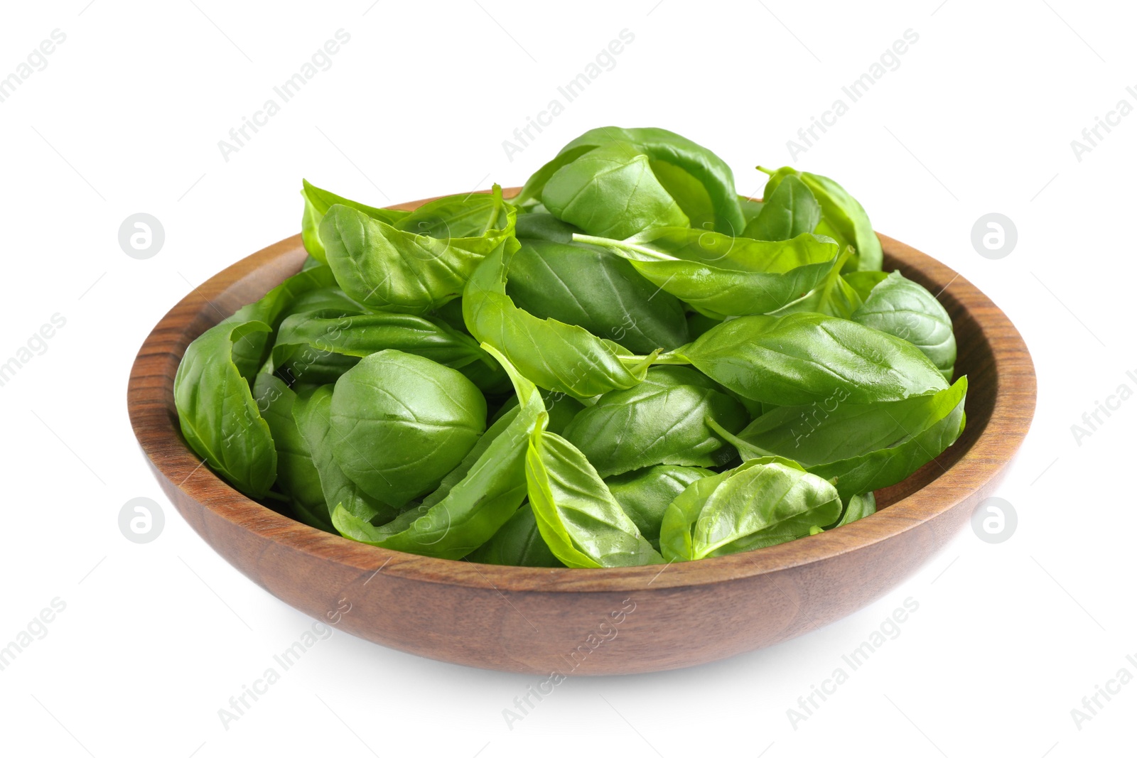 Photo of Fresh basil leaves in wooden bowl isolated on white