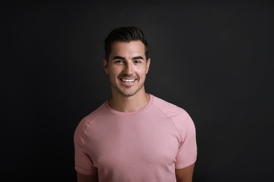 Photo of Portrait of handsome young man on black background