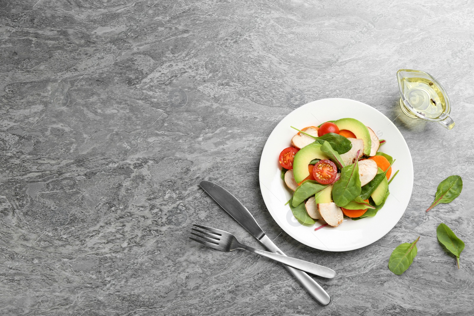 Photo of Delicious fresh chicken salad served on grey table, flat lay. Space for text