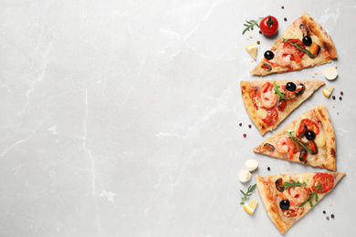 Tasty pizza with seafood and ingredients on light grey marble table, flat lay. Space for text