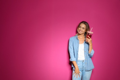 Portrait of beautiful woman with tasty drink on color background