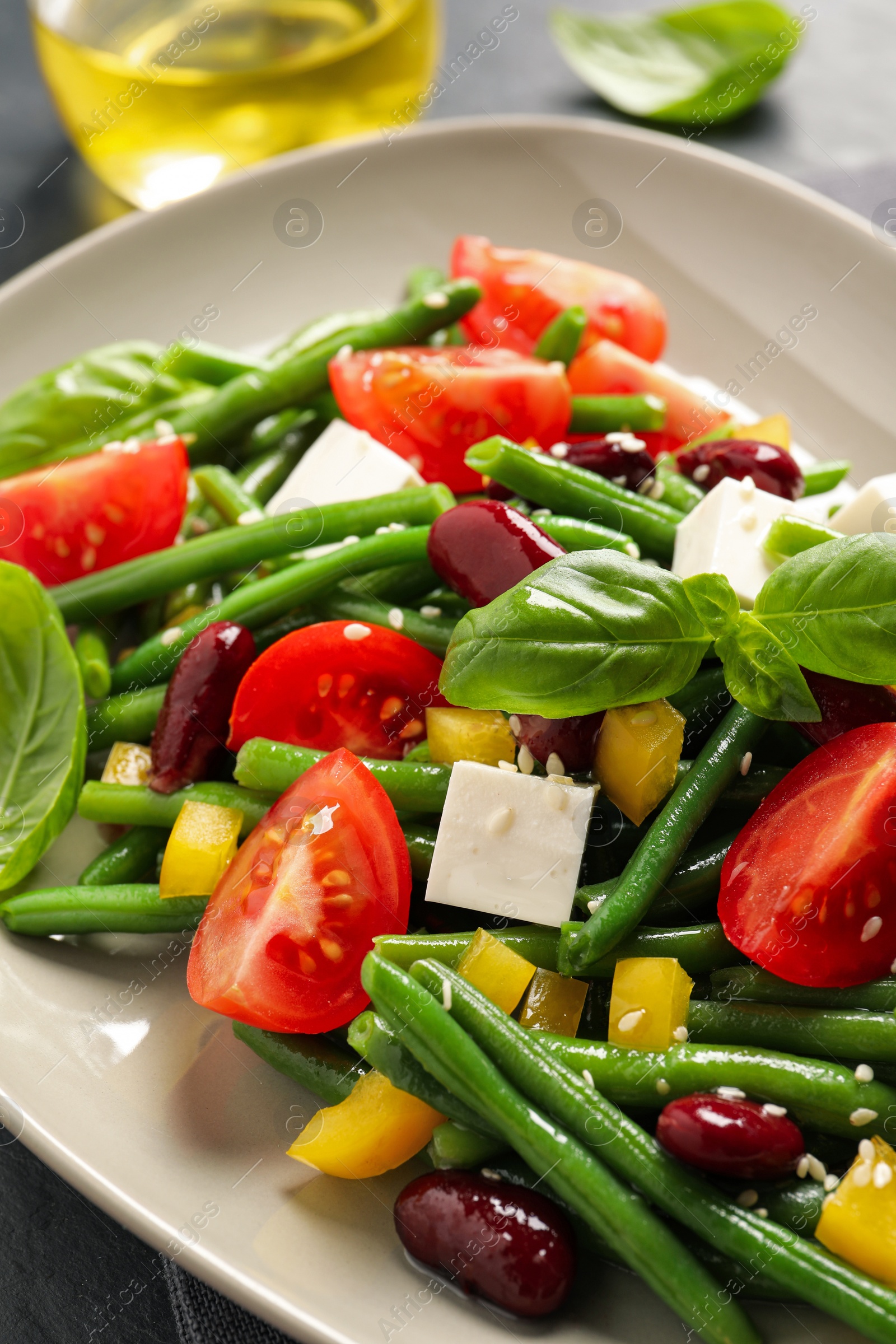 Photo of Plate of tasty salad with green beans on table, closeup